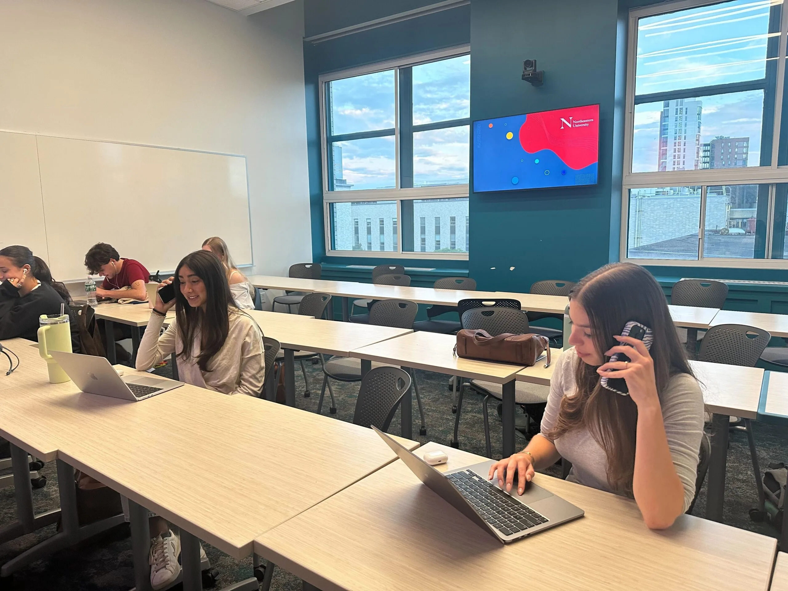 Five students participate in a phone bank at Northeastern University.