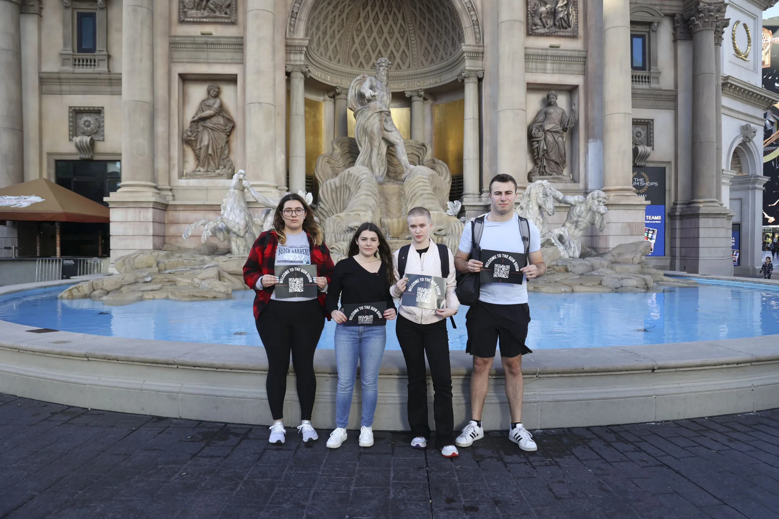 Students Demand Action volunteers holding up Welcome to the Gun Show signs