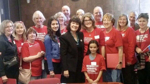 Students Demand Action volunteer Anvitha Doddipalli poses with Moms Demand Action volunteers
