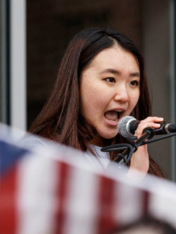 Seo Yoon Yang speaks in a microphone at an event.