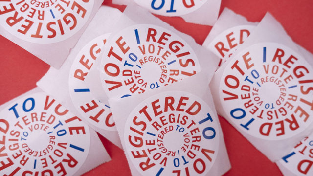 A cluster of register to vote stickers