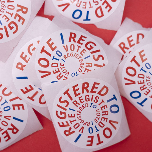 A cluster of register to vote stickers
