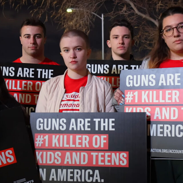 Students Demand Action volunteers holding up signs that say “Guns are the #1 killer of kids and teens in America.”