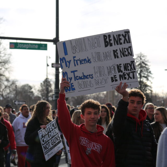 Students rallying and holding signs at Colorado Advocacy Day