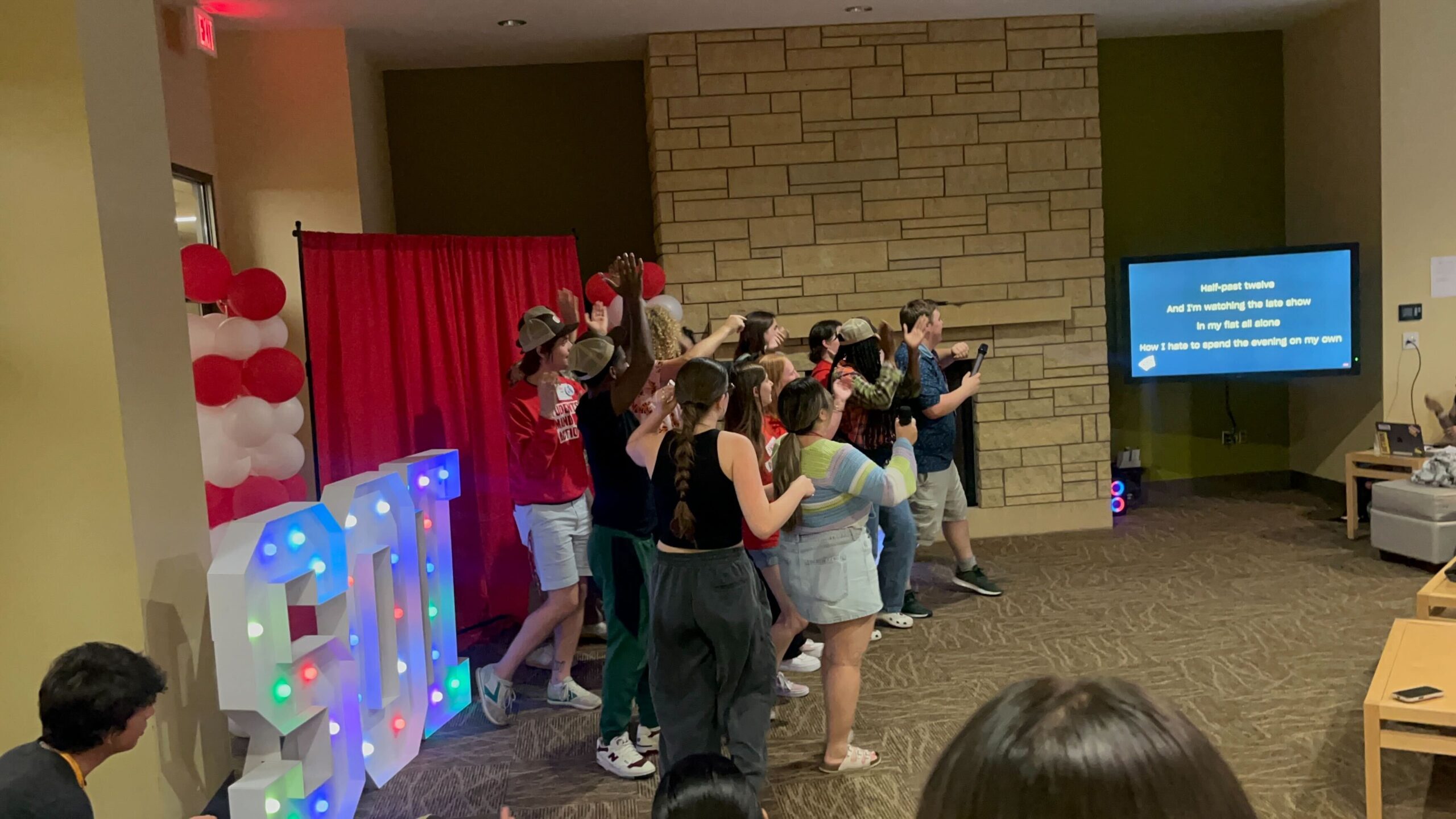 A group of students at the Students Demand Action Summer Organizing Institute gather in a University of Minnesota dorm common area to sing karaoke.