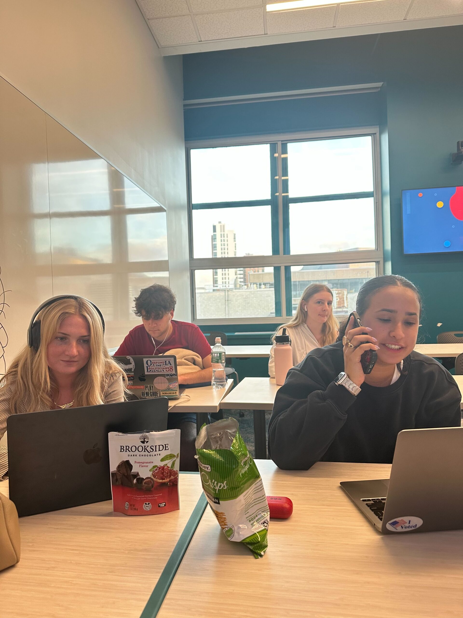 Four students participate in a phone bank at Northeastern University.